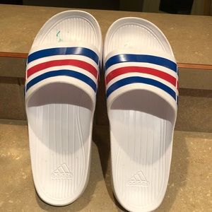 red white and blue adidas slides